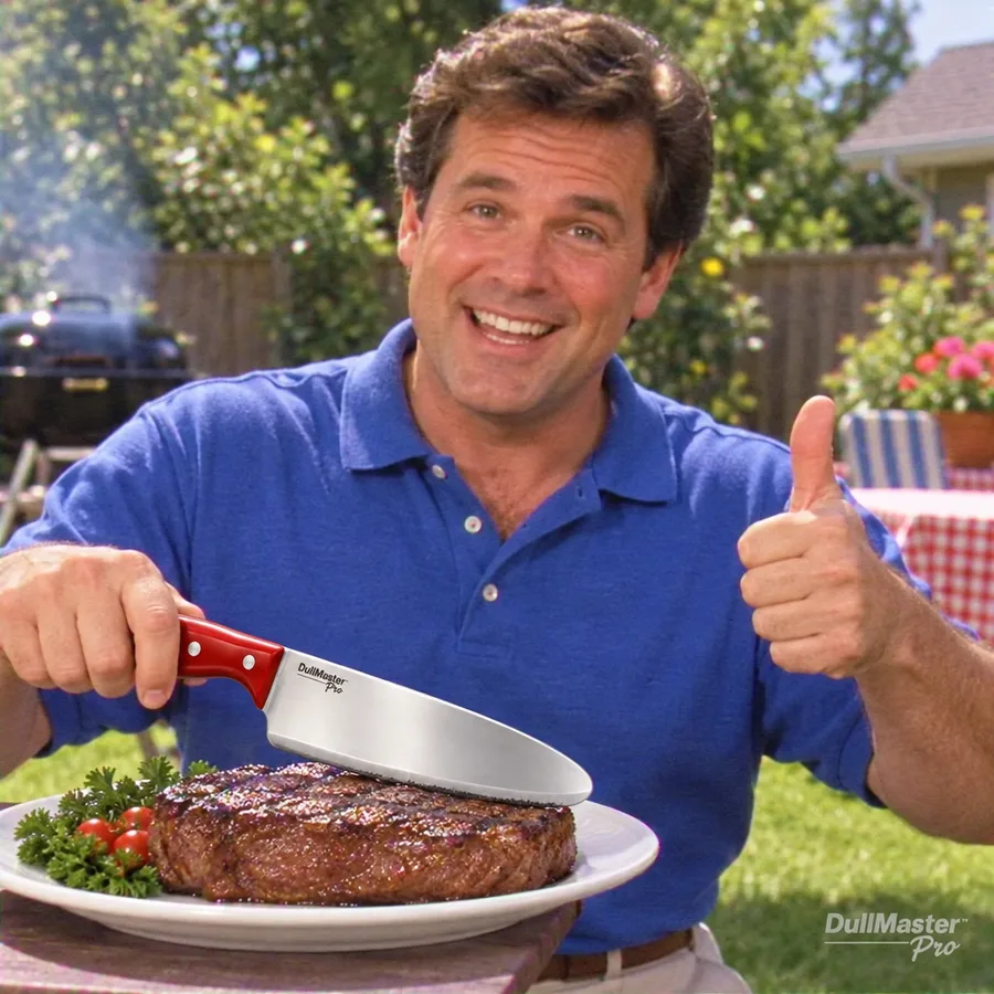 Russ at his grill giving a thumbs up while his DullMaster Pro rests against an uncut steak